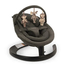 Nuna LEAF™ grow Baby Seat & Rocker in Forest color, featuring plush fabric and three hanging toys: an elephant, a monkey, and a lion.