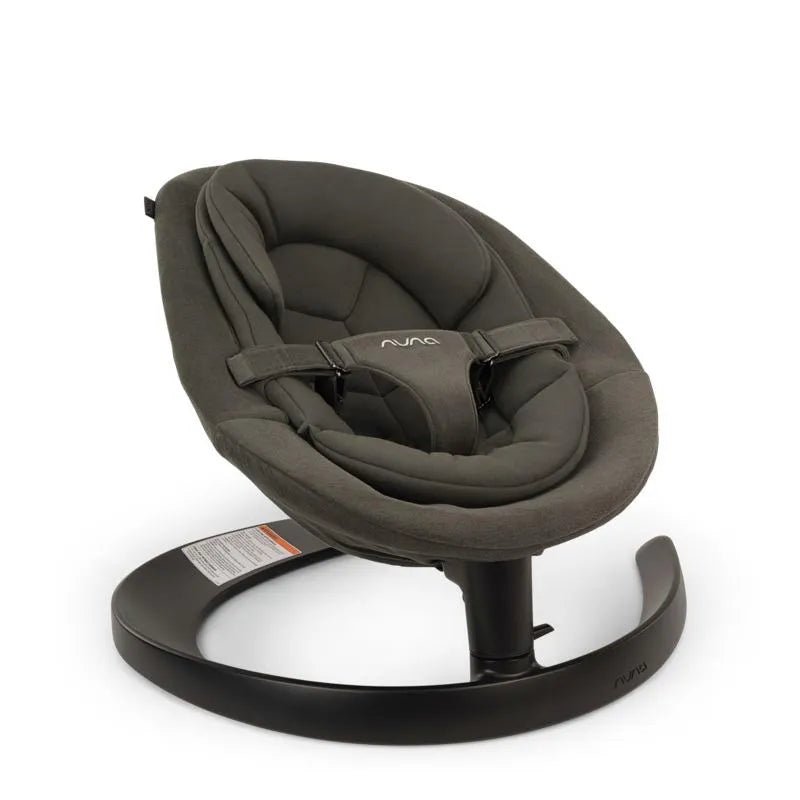 Nuna LEAF™ grow baby seat and rocker in forest green, featuring a padded seat with a safety harness and a stable base.