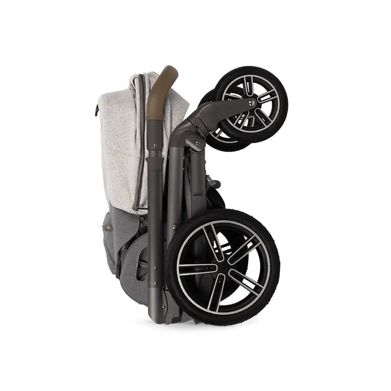 Nuna MIXX next stroller in a folded position, featuring sleek wheels and a stylish grey fabric, ideal for easy storage.