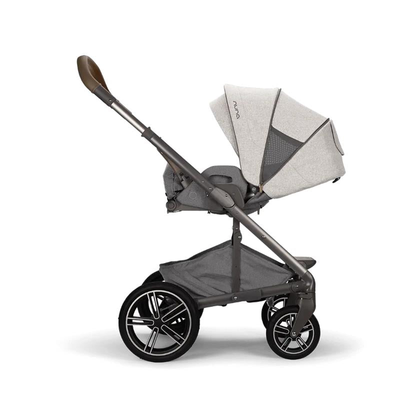 Nuna MIXX™ next Stroller in light gray fabric, featuring a sleek black frame and large wheels, designed for infants.