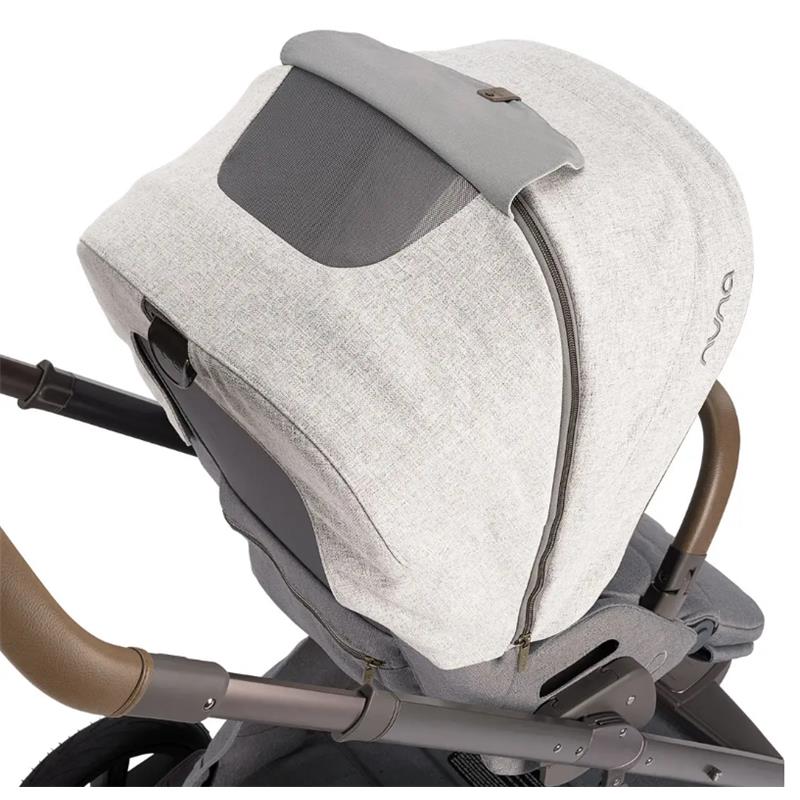 Nuna MIXX™ next Stroller with a light gray canopy and zipper detail, showcasing its sleek design and comfort features.