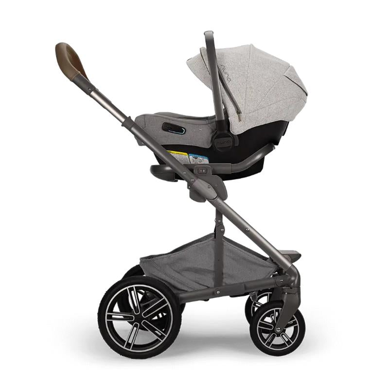 Nuna MIXX™ next stroller in gray with a car seat attached, showcasing a sleek design and durable wheels.