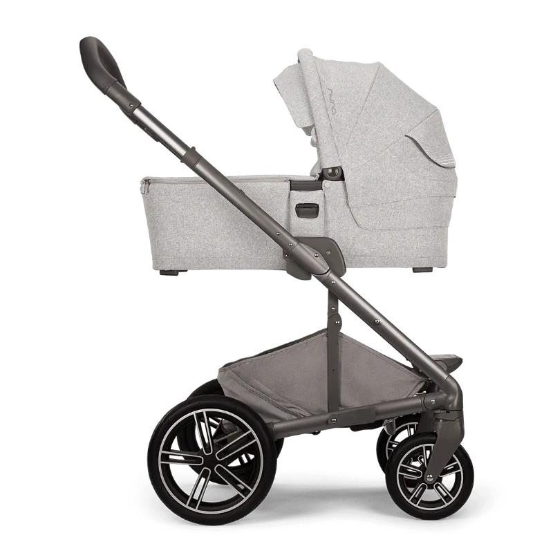 Nuna MIXX™ next stroller in Sterling color, featuring a gray infant seat and sleek black wheels, designed for easy maneuverability.