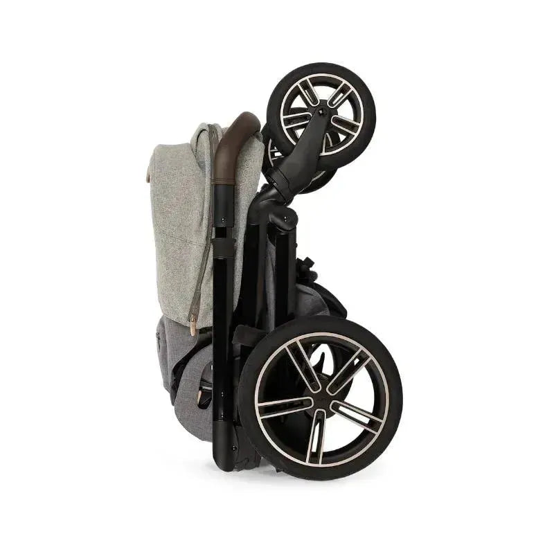 Nuna MIXX™ next Stroller in Monterey, folded with a grey seat fabric and sleek black wheels.