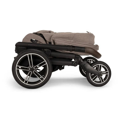 Nuna MIXX™ next stroller in Cedar color, folded with large wheels and a sleek design.