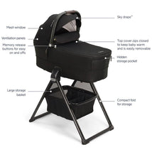 NUNA MIXX Series bassinet in caviar and chocolate, featuring a mesh window, ventilation panels, and large storage basket.