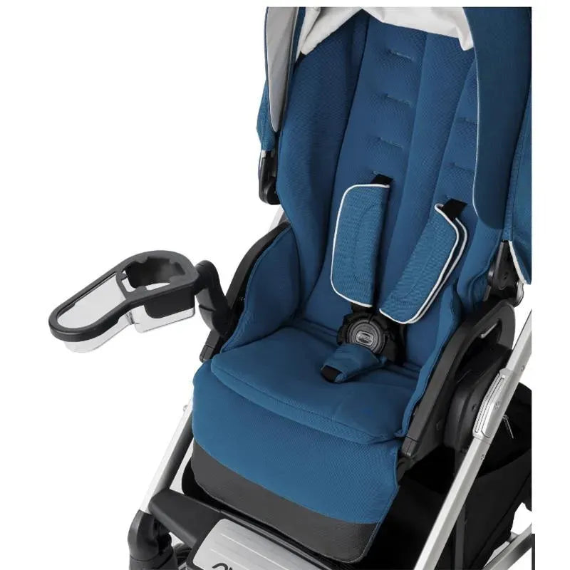 Nuna MIXX™ Snack Tray in black attached to a blue stroller seat with harness and soft padding.