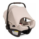 Nuna MIXX™ next + PIPA™ aire rx Travel System in Biscotti, featuring a beige infant car seat with a sun canopy and safety harness.