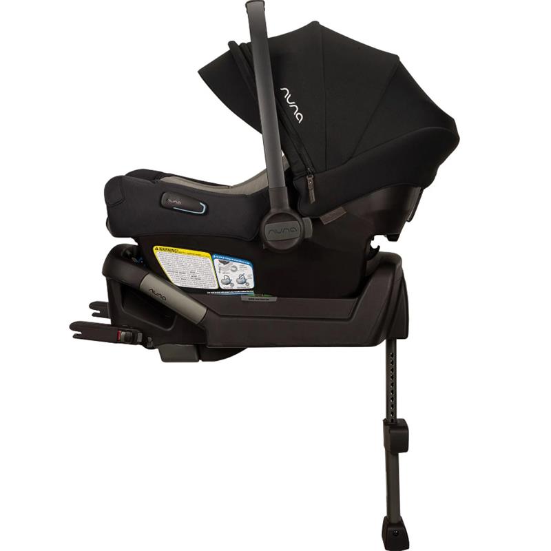 Nuna PIPA aire Infant Car Seat in Caviar color, featuring a canopy, adjustable base, and safety warning labels.