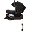 Nuna PIPA aire Infant Car Seat in Caviar color, featuring a canopy, adjustable base, and safety warning labels.