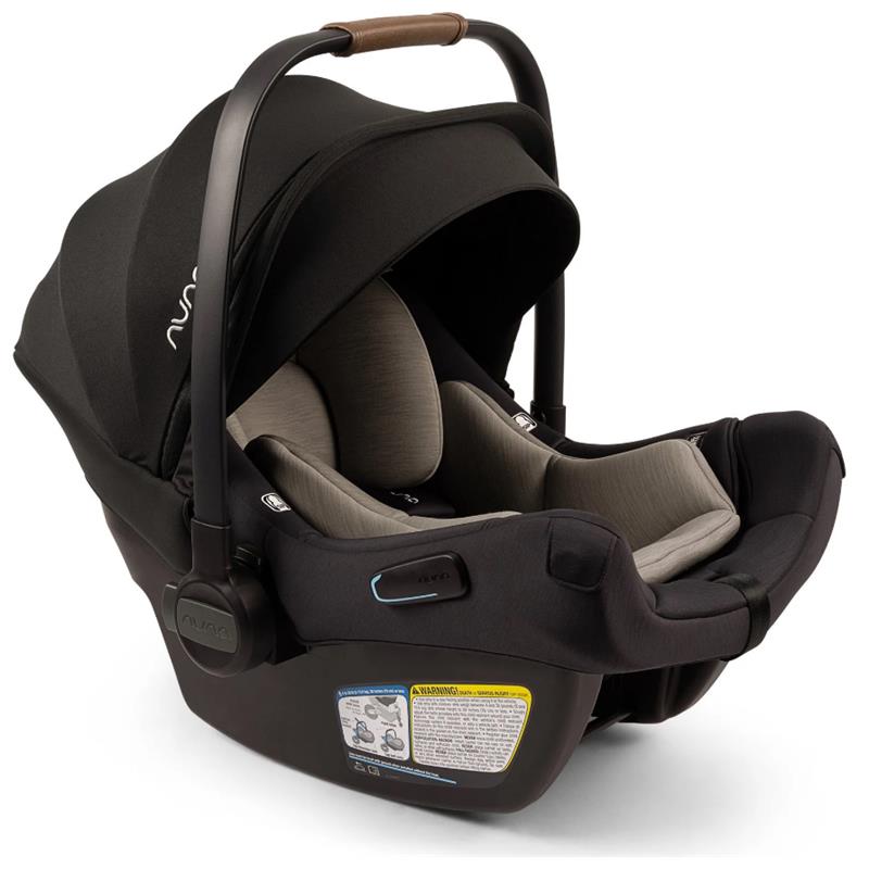 Nuna PIPA™ aire Infant Car Seat in Caviar color, featuring a sleek design, adjustable canopy, and safety labels.