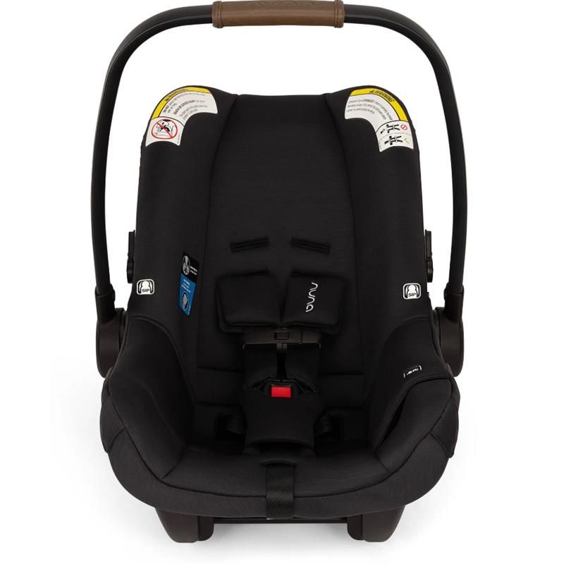 Nuna PIPA™ aire Infant Car Seat in Caviar color, featuring safety labels, adjustable handle, and secure harness system.