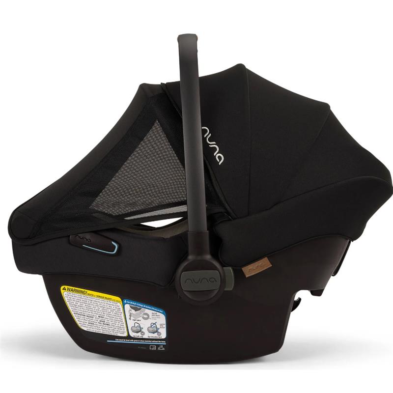 Nuna PIPA™ aire infant car seat in Caviar color, featuring a mesh canopy and safety labels visible on the base.