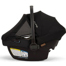 Nuna PIPA™ aire infant car seat in Caviar color, featuring a mesh canopy and safety labels visible on the base.