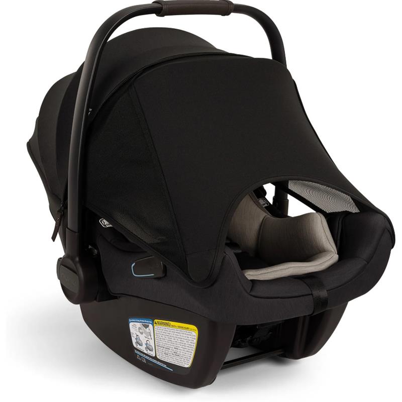 Nuna PIPA™ aire Infant Car Seat in Caviar color with adjustable canopy and safety instructions visible on the base.