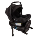 Nuna Pipa Aire Rx infant car seat in Caviar/Chocolate, featuring a removable canopy and safety labels on the base.
