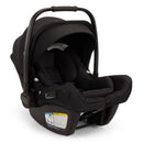 Nuna Pipa Aire Rx Infant Car Seat in Caviar/Chocolate, featuring a secure harness, removable canopy, and safety instruction label.