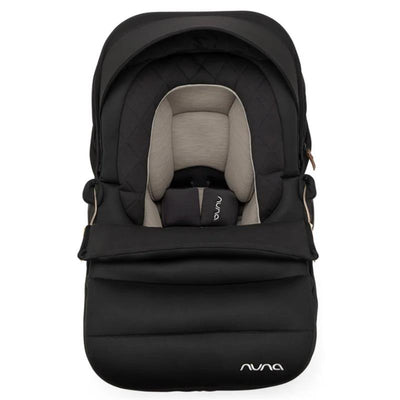 Nuna PIPA™ Series Winter Footmuff in Caviar, featuring a sleek black exterior and cozy quilted interior, designed for infant comfort.