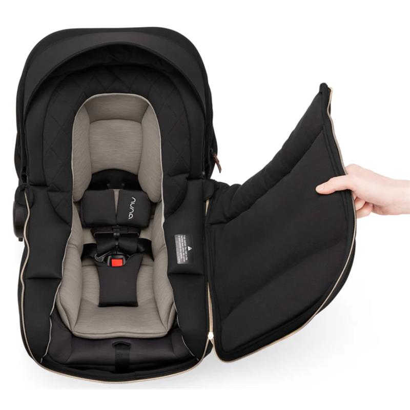 Nuna PIPA™ Series winter footmuff in Caviar, featuring a black exterior and a light gray interior with a zippered opening.