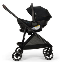 Nuna PIPA™ urbn Flex System™ in Caviar color, featuring a car seat secured in a black stroller with a canopy.
