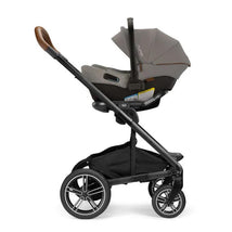 Nuna PIPA URBN infant car seat attached to the MIXX Next stroller in Granite color, featuring a sleek design and large wheels.