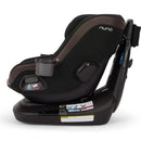 Nuna REVV™ maxx Rotating Convertible Car Seat in Caviar color, featuring a cup holder and safety labels.