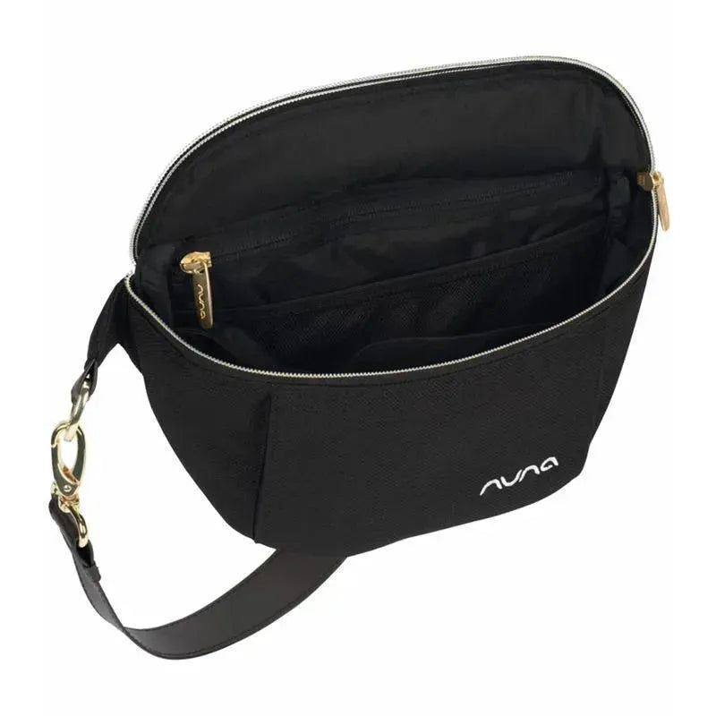 Black Nuna Stroller Sling Bag with gold zippers, featuring an open compartment and adjustable strap for easy carrying.