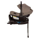Nuna Swiv + Pipa Aire Rx Travel System in Cedar color, featuring a car seat with a sun canopy and safety labels.