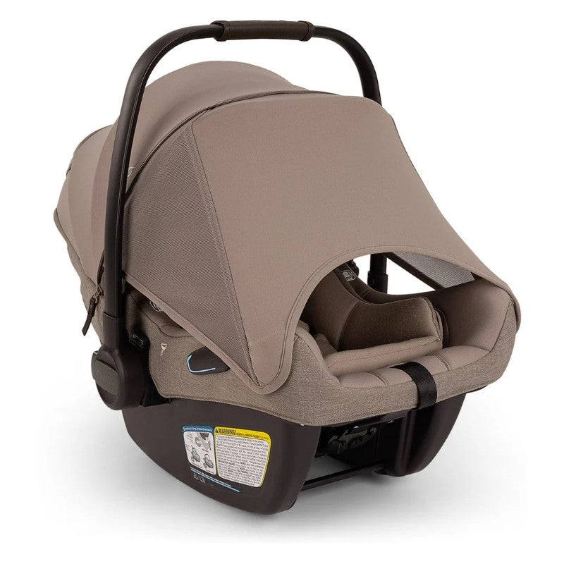 Travel system car seat in cedar color with a large canopy and safety harness, designed for infants.