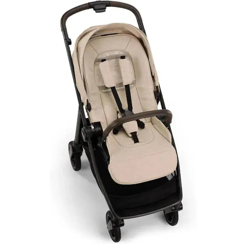 Nuna SWIV™ Stroller in Biscotti color, featuring a lightweight framed seat, safety harness, and upholstered padding.