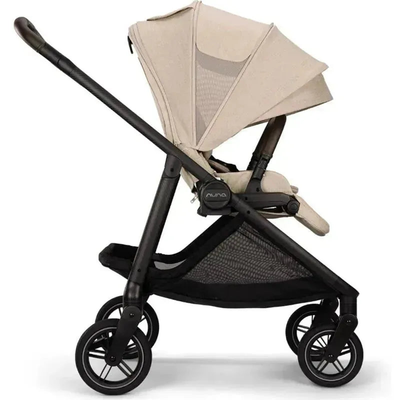 Nuna SWIV™ stroller in Biscotti color, featuring a reclining seat, adjustable canopy, and sturdy black frame.