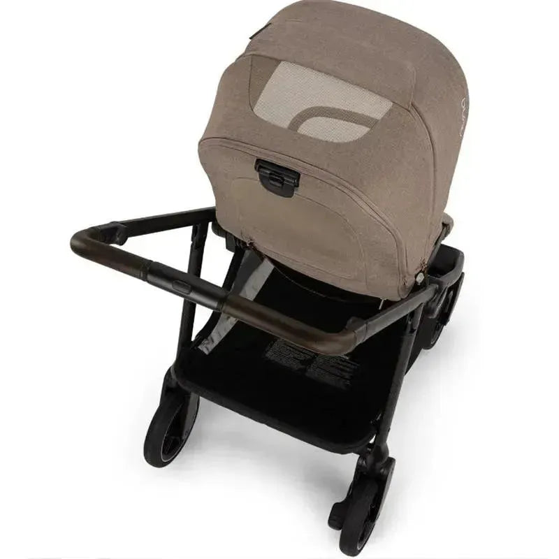 Nuna SWIV™ stroller in Cedar color, featuring a soft, tan seat with a mesh backrest and a sturdy black frame.