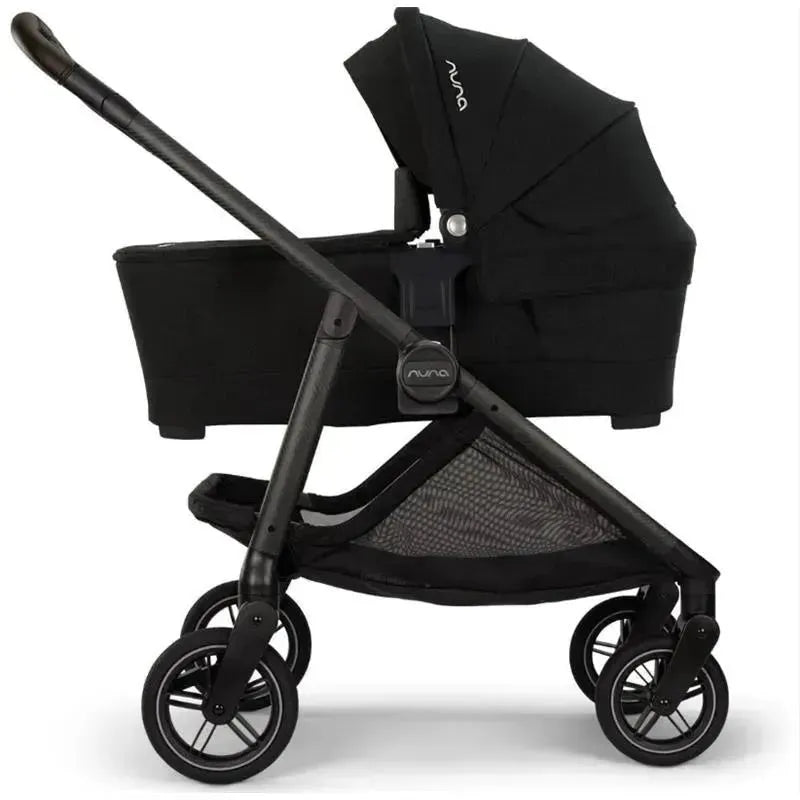 Nuna SWIV™ Stroller in Cedar color, featuring a removable bassinet, adjustable canopy, and sturdy black frame with four wheels.