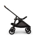Nuna SWIV™ Stroller in Chai color, featuring a sleek black frame and a spacious mesh storage basket.