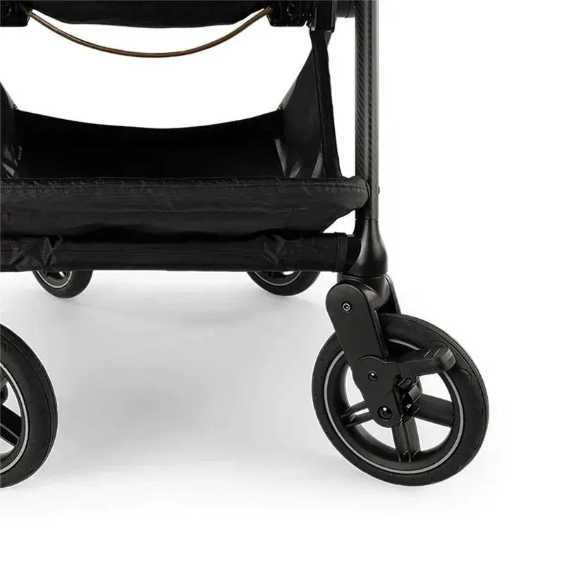 Nuna SWIV™ Stroller in Chai color, focused on the wheels and lower storage basket, showcasing its sleek design.