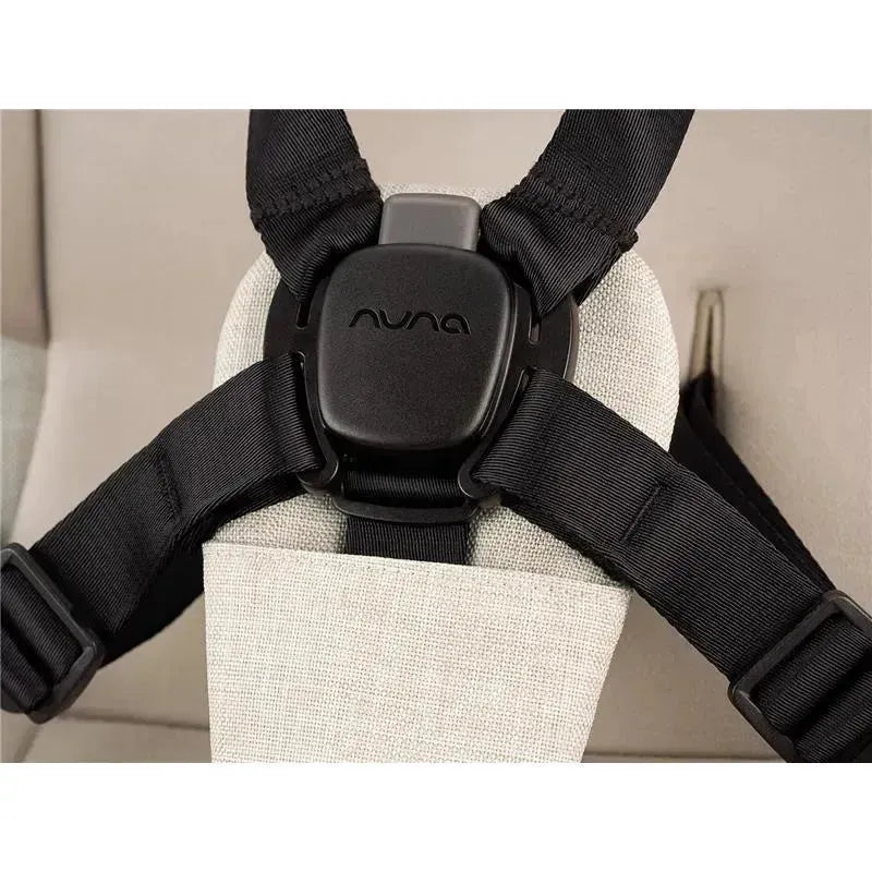 Nuna SWIV™ Stroller harness with adjustable black straps and a padded beige seat for child safety support.