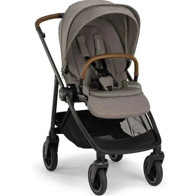 Nuna SWIV™ Stroller in Granite color featuring a spacious seat, adjustable canopy, and brown handlebar.