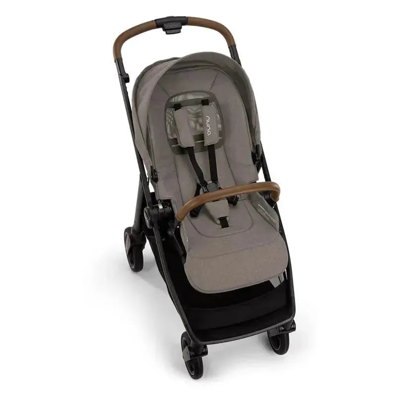 Nuna SWIV™ stroller in Granite color with a padded seat, safety harness, and a brown handle, on wheels.