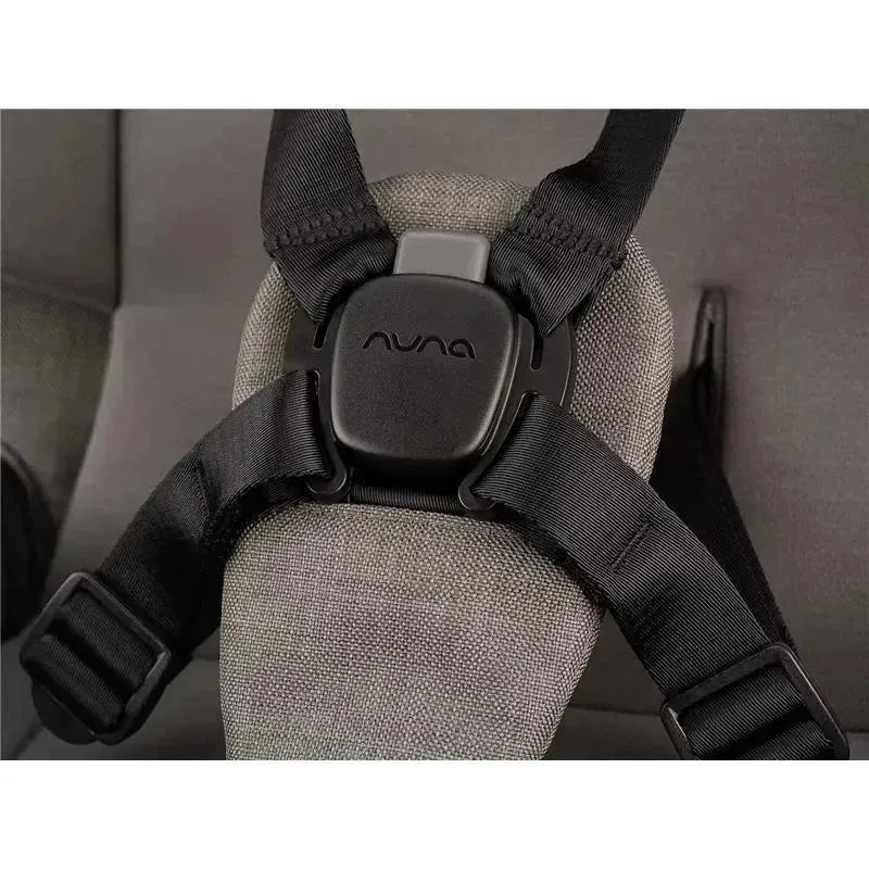 Nuna SWIV™ Stroller harness system featuring a secure black buckle and adjustable straps on a gray fabric seat.