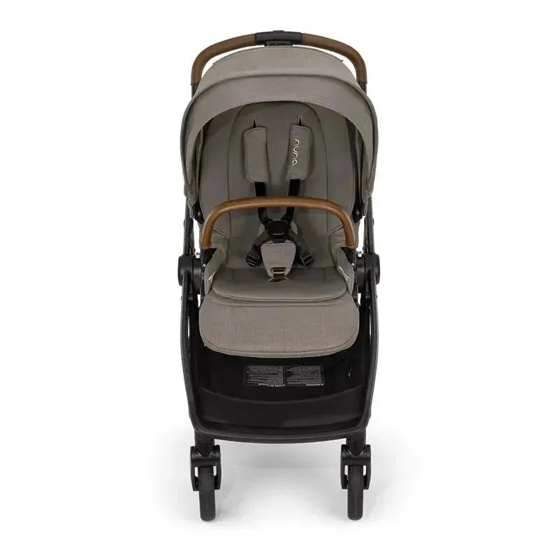 Nuna SWIV™ Stroller in Granite color with a padded seat, safety harness, and wooden handlebar.