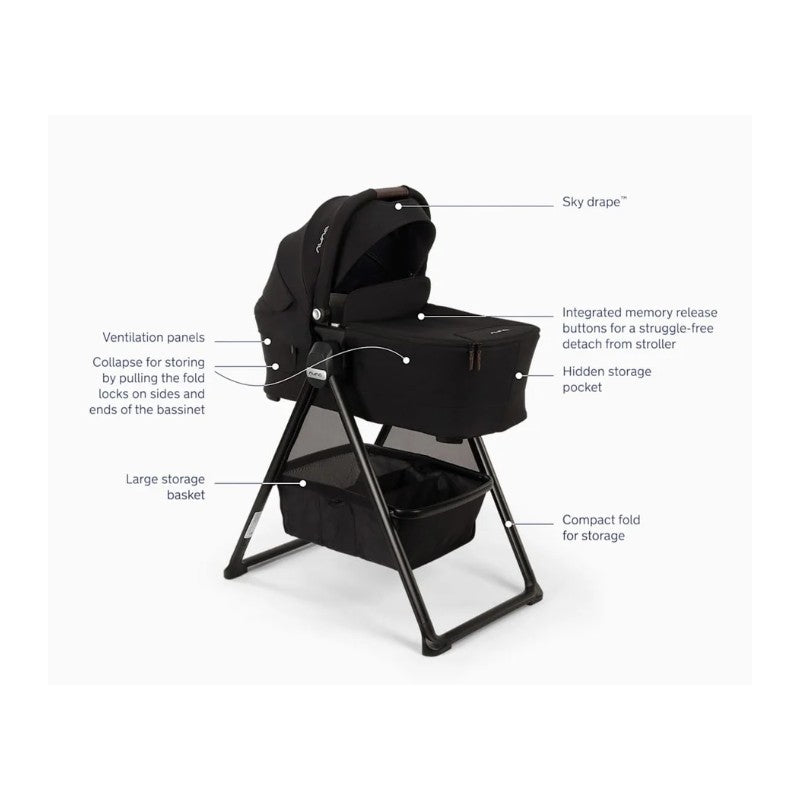 Nuna Swiv stroller bundle in Caviar color with a bassinet on a stand, featuring storage basket and ventilation panels.