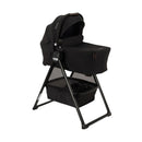 Nuna Swiv Stroller with a black bassinet on a stand, featuring a zippered compartment and a lower storage basket.