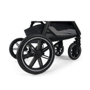 Black wheels of the Nuna Triv LX stroller, featuring a sleek design and sturdy construction, with a mesh storage basket visible.