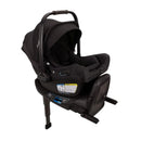 Nuna Triv Lx + Pipa Aire Rx travel system in Caviar color featuring a sleek car seat with safety labels and an adjustable handle.