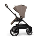 Nuna Triv Lx stroller in Cedar color, featuring a sleek design, adjustable canopy, and spacious storage basket.