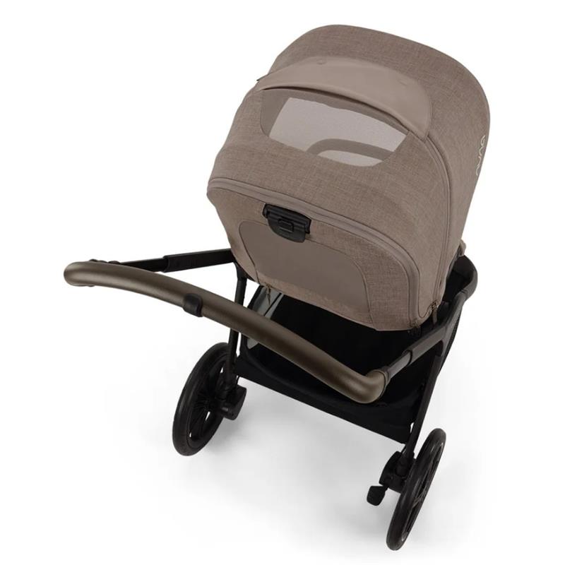 Nuna Triv Lx stroller with a Cedar fabric, featuring a canopy and a black frame, viewed from above.