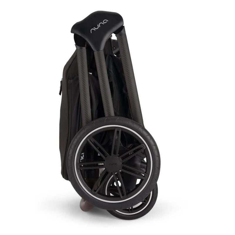 Nuna Triv Lx stroller folded with a black frame and large wheels, showcasing compact design and portability.
