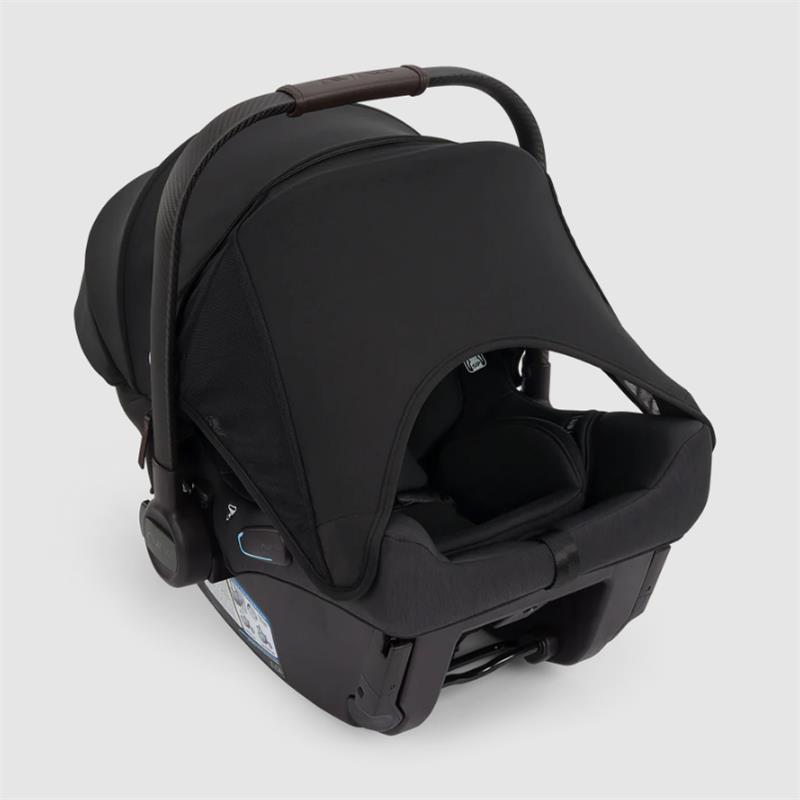 Nuna Triv Lx + Pipa Urbn Travel System in Caviar color, featuring a compact infant car seat with a sun canopy and safety harness.