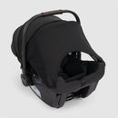 Nuna Triv Lx + Pipa Urbn Travel System in Caviar color, featuring a compact infant car seat with a sun canopy and safety harness.