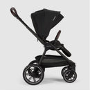 Nuna Triv Lx travel system in caviar color, featuring a sturdy frame, large wheels, and a reclined seat with a canopy.